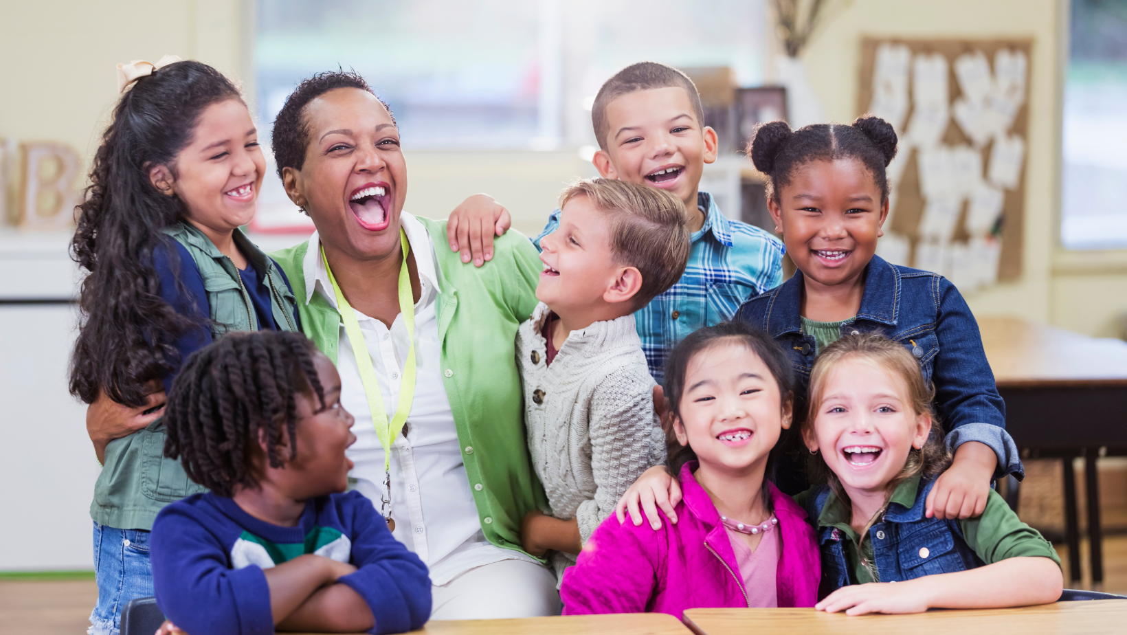 children hugging their teacher