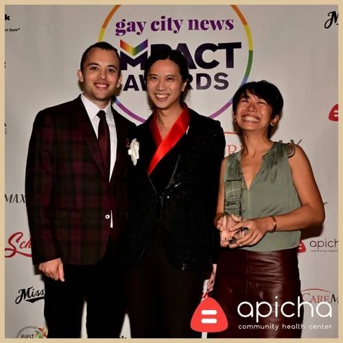 Timothy Au and Melanie Dulfo accepting the Gay City News Impact Award