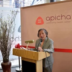 Therese Remarks.jpg company owner speaking in a podium
