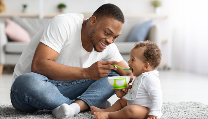 father feeding child