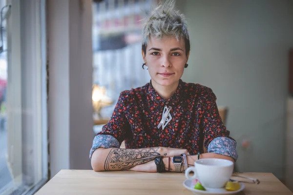 A transwoman having a coffee