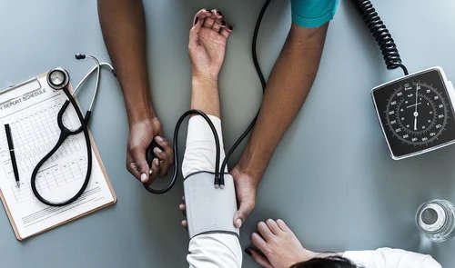 Nurse checking the blood pressure of the patient